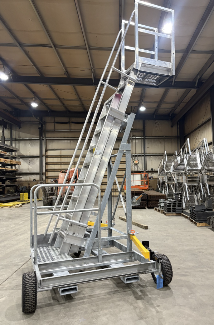 Side-Load Porta-Rack portable truck and railcar access platform with side-access ladder inside a fabrication shop